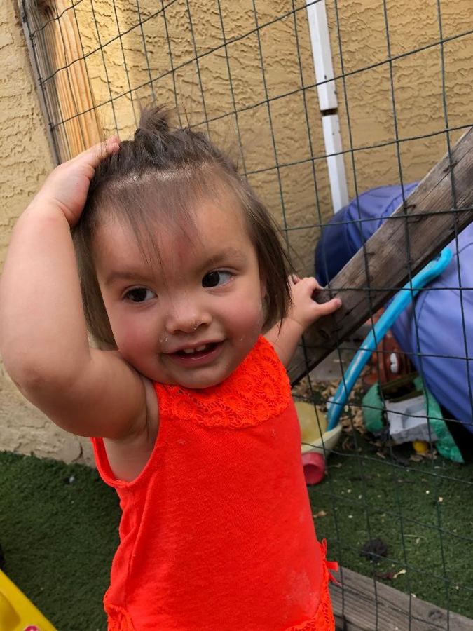 A toddler smiling mid-play