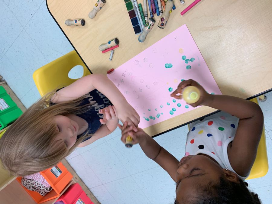 A teacher reading with two young children