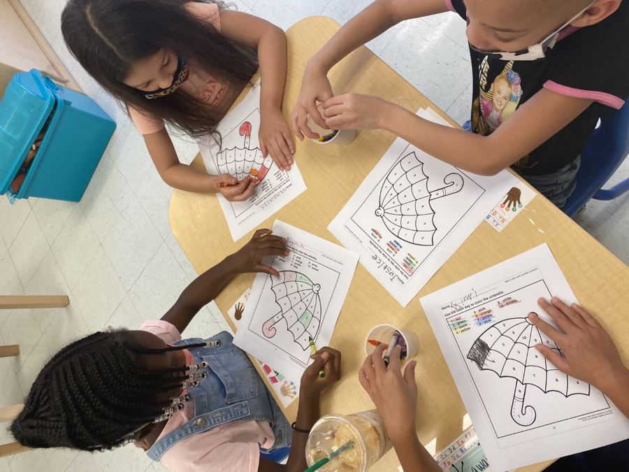 Children colouring together at the table